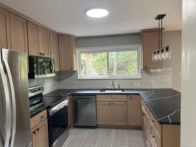 kitchen with appliances with stainless steel finishes, a sink, dark countertops, backsplash, and ornamental molding