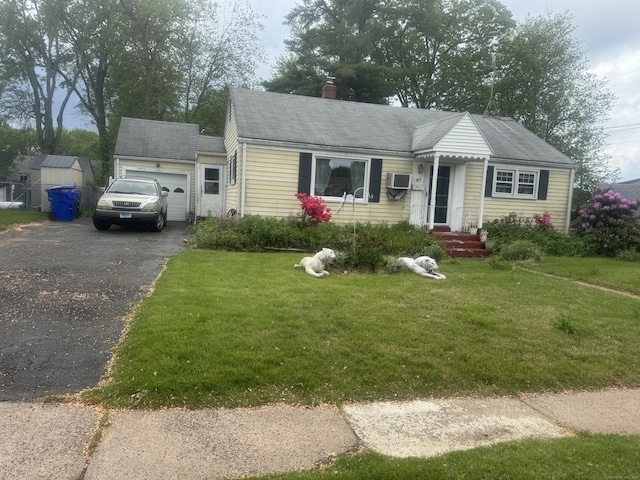 57 Britt Rd, East Hartford, CT 06118 - view of front of home featuring asphalt driveway, an attached garage, a front lawn, and a chimney