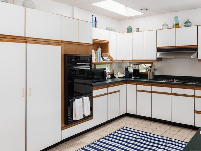5 New Street Ext, Wilton, CT 06897 - kitchen featuring under cabinet range hood, a skylight, white cabinetry, gas cooktop, and light tile patterned floors