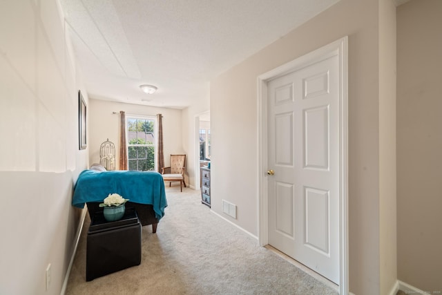 hall featuring carpet flooring and baseboards