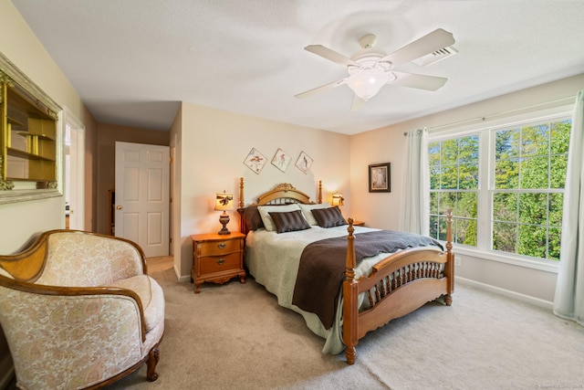 bedroom with light carpet, baseboards, and ceiling fan