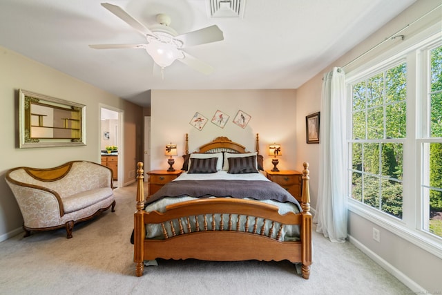bedroom featuring light carpet, baseboards, and ceiling fan