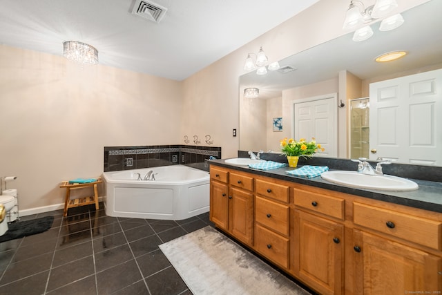 bathroom featuring tile patterned flooring, a shower stall, a bath, double vanity, and baseboards
