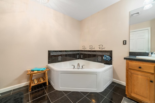 full bathroom with tile patterned flooring, a bath, vanity, and baseboards