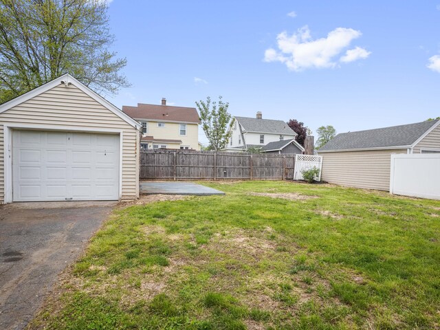 31 Emerson St, Norwalk, CT 06855 - view of yard featuring an outbuilding, driveway, and a detached garage