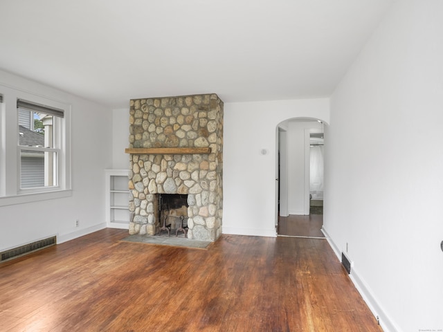 31 Emerson St, Norwalk, CT 06855 - unfurnished living room featuring arched walkways, wood finished floors, a fireplace, and baseboards