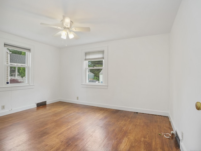 31 Emerson St, Norwalk, CT 06855 - empty room with plenty of natural light, hardwood / wood-style floors, and baseboards