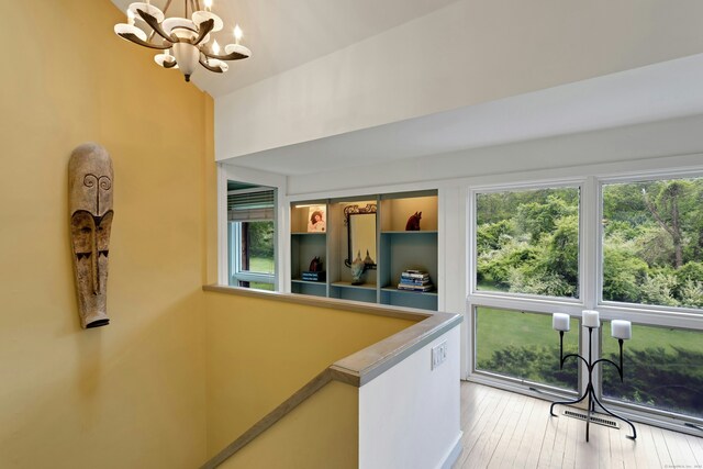 32 Beeholm Rd, Redding, CT 06896 - hallway with a chandelier and light wood finished floors
