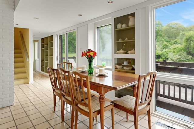 32 Beeholm Rd, Redding, CT 06896 - dining area featuring built in features, light tile patterned floors, stairway, healthy amount of natural light, and recessed lighting