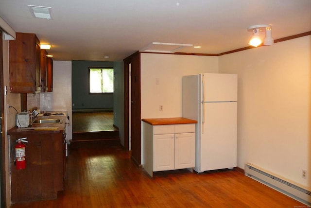 32 Beeholm Rd, Redding, CT 06896 - kitchen with freestanding refrigerator, a baseboard radiator, a sink, dark wood-type flooring, and white cabinetry