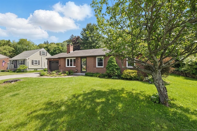 149 Edgewood Dr, Torrington, CT 06790 - view of front facade with an attached garage, brick siding, a chimney, concrete driveway, and a front yard
