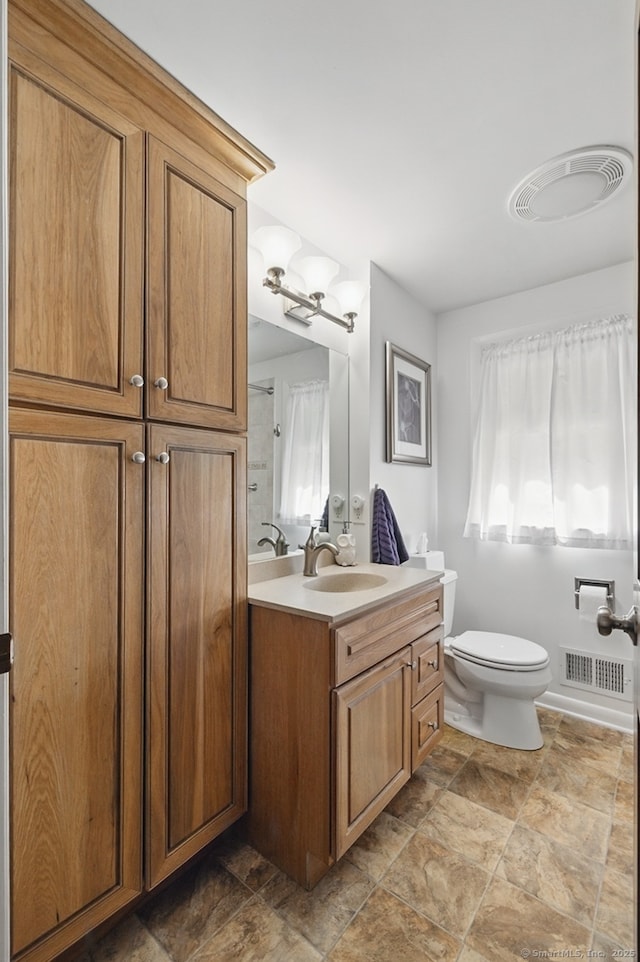 149 Edgewood Dr, Torrington, CT 06790 - bathroom with vanity, toilet, and stone finish flooring