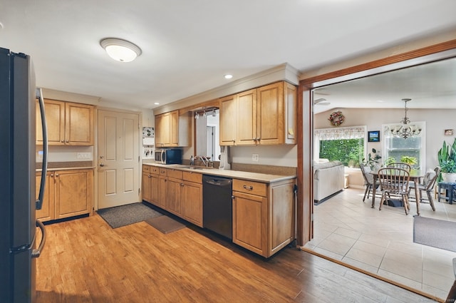 149 Edgewood Dr, Torrington, CT 06790 - kitchen with appliances with stainless steel finishes, light countertops, a chandelier, a sink, and light wood finished floors