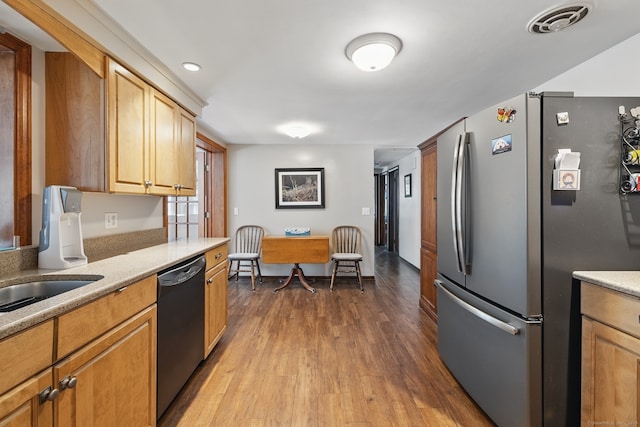 149 Edgewood Dr, Torrington, CT 06790 - kitchen with freestanding refrigerator, dishwashing machine, dark wood-type flooring, and light countertops