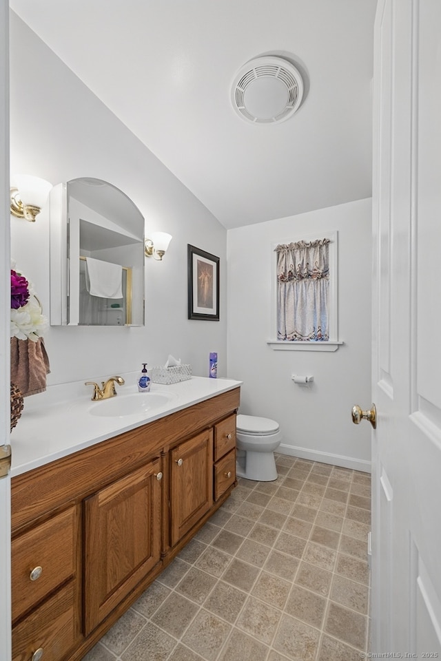 149 Edgewood Dr, Torrington, CT 06790 - bathroom featuring vanity, toilet, lofted ceiling, and baseboards