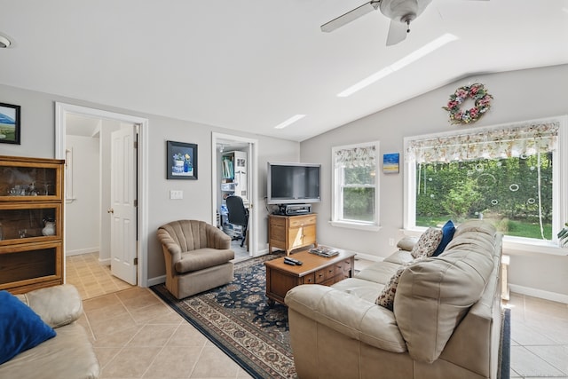 149 Edgewood Dr, Torrington, CT 06790 - living area with vaulted ceiling, ceiling fan, light tile patterned floors, a skylight, and baseboards