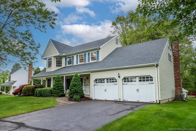 9 Rosick Rd, Wallingford, CT 06492 - colonial home featuring an attached garage, a porch, asphalt driveway, a front lawn, and a chimney