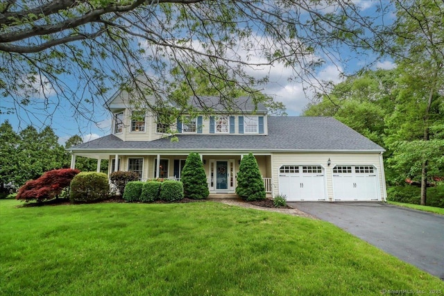 9 Rosick Rd, Wallingford, CT 06492 - view of front of property featuring a garage, driveway, a front yard, and covered porch