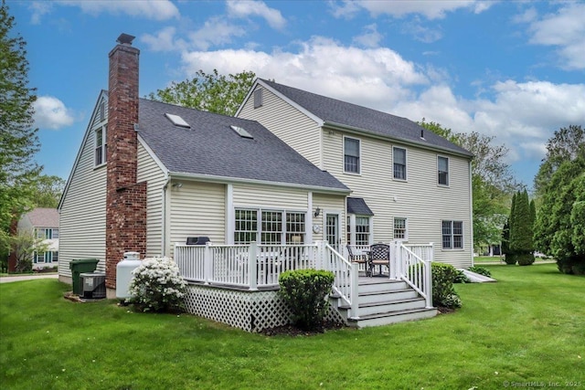 9 Rosick Rd, Wallingford, CT 06492 - rear view of house featuring a chimney, a yard, a wooden deck, a shingled roof, and cooling unit