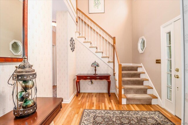 9 Rosick Rd, Wallingford, CT 06492 - foyer entrance featuring wood finished floors, stairs, wallpapered walls, baseboards, and a high ceiling