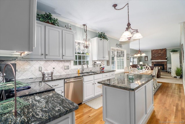 9 Rosick Rd, Wallingford, CT 06492 - kitchen featuring stainless steel dishwasher, a sink, backsplash, a chandelier, and a kitchen island