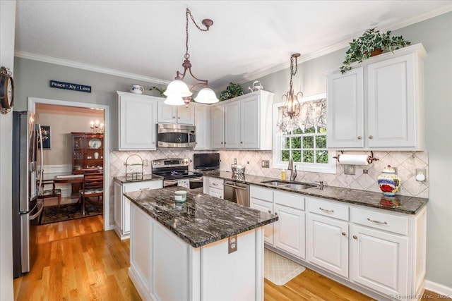 9 Rosick Rd, Wallingford, CT 06492 - kitchen with appliances with stainless steel finishes, a sink, white cabinetry, light wood-type flooring, and ornamental molding