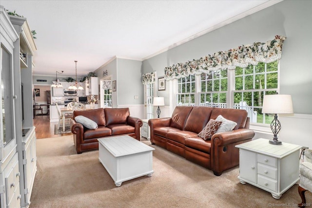 9 Rosick Rd, Wallingford, CT 06492 - living area with ornamental molding, light colored carpet, and a chandelier
