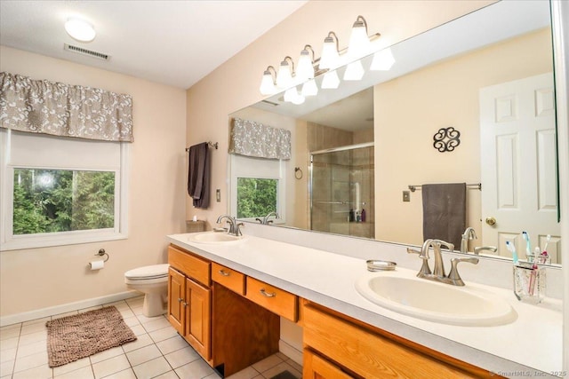 9 Rosick Rd, Wallingford, CT 06492 - full bathroom featuring tile patterned floors, a shower stall, toilet, double vanity, and baseboards