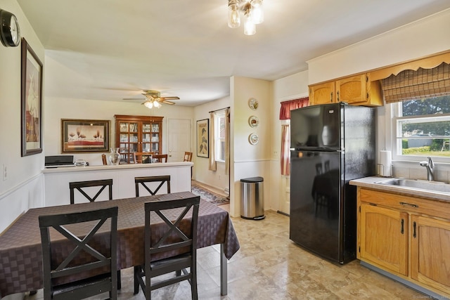 90 Russell Rd, Stratford, CT 06614 - kitchen with freestanding refrigerator, a sink, light countertops, ceiling fan, and brown cabinets