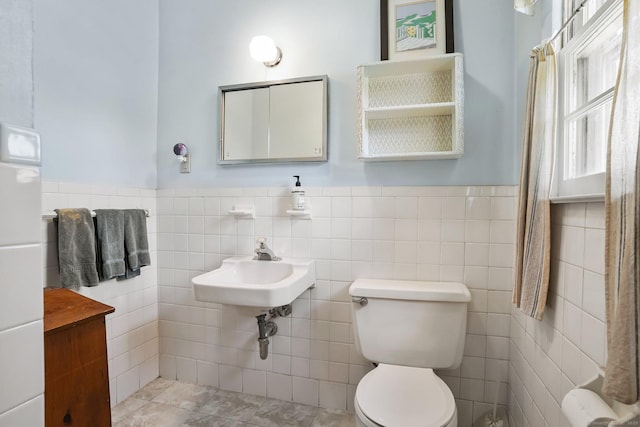 90 Russell Rd, Stratford, CT 06614 - bathroom with tile walls, toilet, a sink, and wainscoting