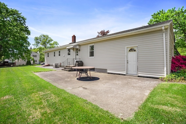 90 Russell Rd, Stratford, CT 06614 - back of property with a patio, a lawn, a chimney, and central air condition unit