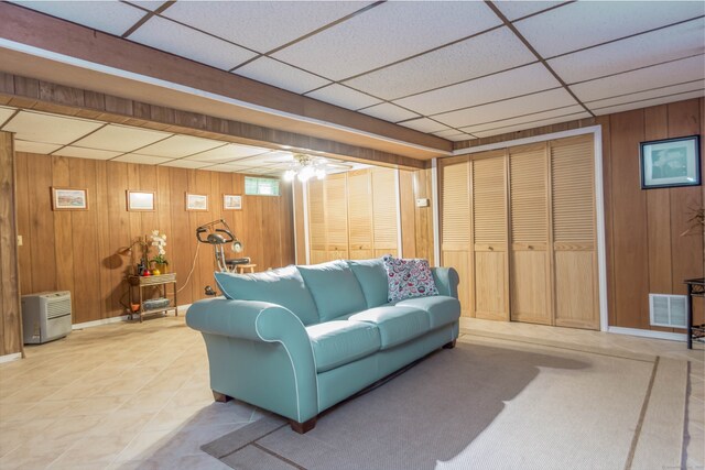 27 Lansing Ave, Trumbull, CT 06611 - living area with wood walls, a drop ceiling, light tile patterned floors, and baseboards