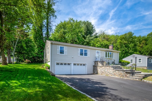 27 Lansing Ave, Trumbull, CT 06611 - view of front of property with driveway, a garage, a chimney, and a front lawn