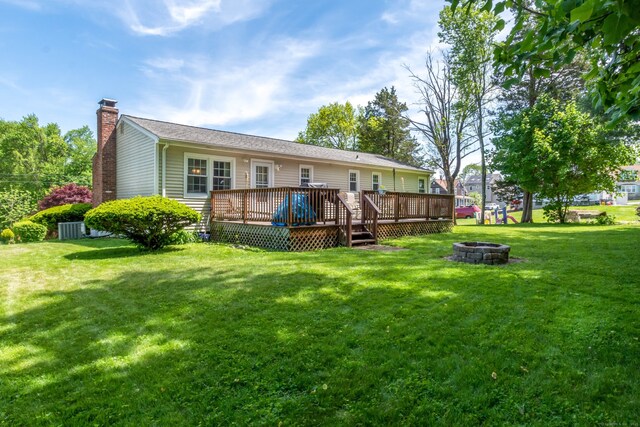 27 Lansing Ave, Trumbull, CT 06611 - rear view of property featuring an outdoor fire pit, a chimney, a yard, a deck, and central AC