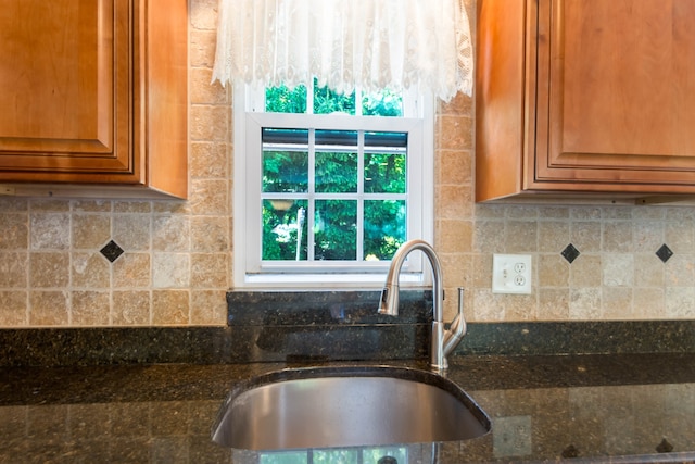 27 Lansing Ave, Trumbull, CT 06611 - kitchen featuring a sink, dark stone countertops, brown cabinetry, and backsplash