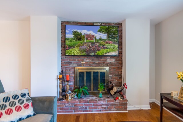 27 Lansing Ave, Trumbull, CT 06611 - living area with wood finished floors, baseboards, and a brick fireplace