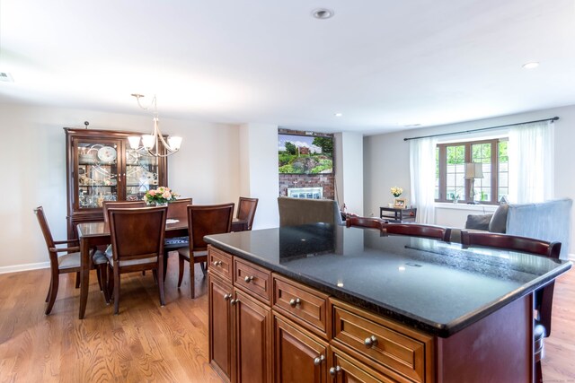 27 Lansing Ave, Trumbull, CT 06611 - kitchen with light wood-type flooring, a breakfast bar, recessed lighting, open floor plan, and brown cabinetry