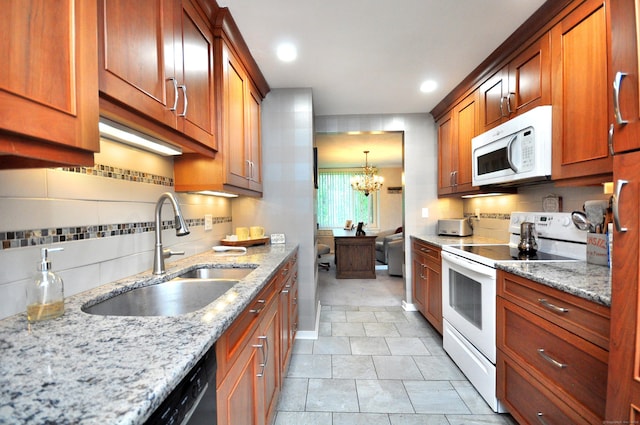 5 Spyglass Dr Unit 5, Avon, CT 06001 - kitchen with white appliances, a sink, a chandelier, backsplash, and light stone counters