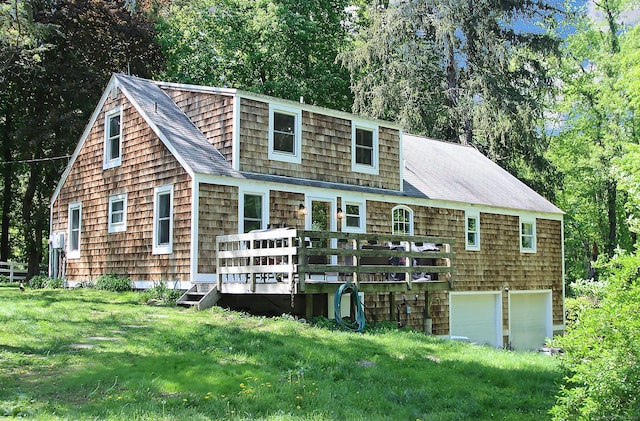 113 Codfish Hill Rd, Bethel, CT 06801 - back of property with a deck, a lawn, an attached garage, and a shingled roof
