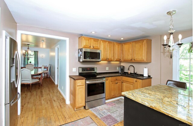 113 Codfish Hill Rd, Bethel, CT 06801 - kitchen with appliances with stainless steel finishes, a chandelier, a sink, light wood-type flooring, and pendant lighting
