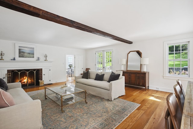 336 Old Branchville Rd, Ridgefield, CT 06877 - living room featuring light wood-type flooring, a fireplace, beamed ceiling, and baseboards