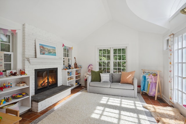 336 Old Branchville Rd, Ridgefield, CT 06877 - living area featuring a fireplace, vaulted ceiling, and tile patterned flooring