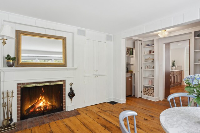 336 Old Branchville Rd, Ridgefield, CT 06877 - living area with hardwood / wood-style flooring, a fireplace, and built in features