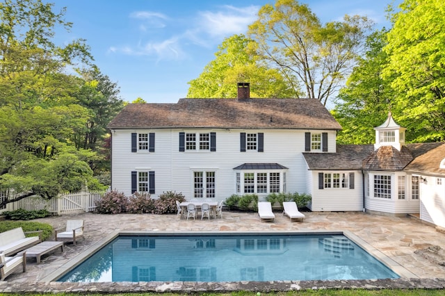 336 Old Branchville Rd, Ridgefield, CT 06877 - rear view of property with a patio, a chimney, and an outdoor pool