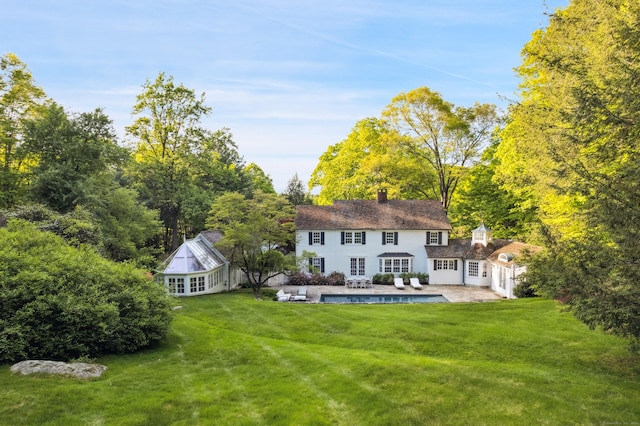336 Old Branchville Rd, Ridgefield, CT 06877 - rear view of house featuring french doors, a patio, a yard, a chimney, and an outbuilding