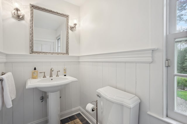336 Old Branchville Rd, Ridgefield, CT 06877 - bathroom featuring a wainscoted wall, toilet, a decorative wall, and a sink
