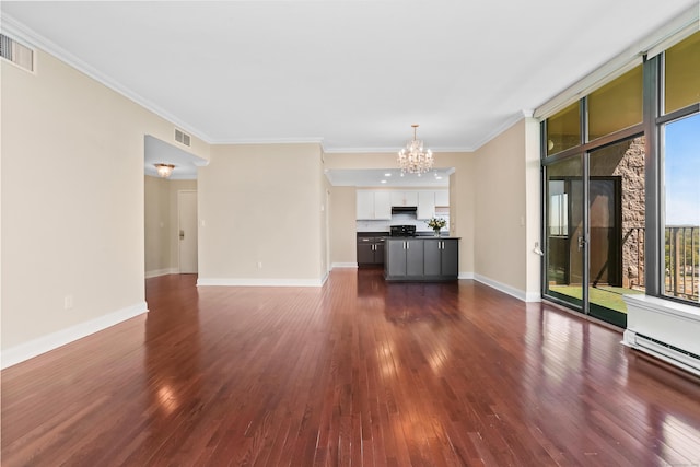 3200 Park Ave Unit 10A2, Bridgeport, CT 06604 - unfurnished living room featuring a chandelier, dark wood-type flooring, baseboards, and crown molding