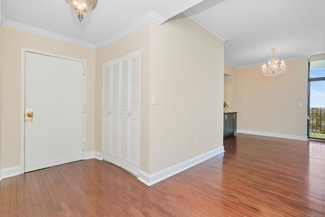 3200 Park Ave Unit 10A2, Bridgeport, CT 06604 - entryway with a chandelier, wood-type flooring, crown molding, and baseboards
