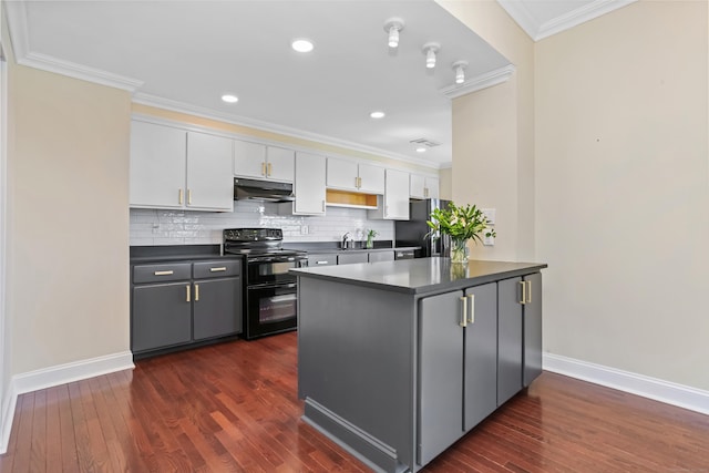 3200 Park Ave Unit 10A2, Bridgeport, CT 06604 - kitchen featuring black appliances, under cabinet range hood, dark countertops, white cabinetry, and ornamental molding