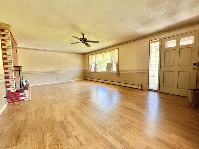 343 Lebanon Ave, Lebanon, CT 06249 - unfurnished living room featuring baseboard heating, a textured ceiling, light wood-style flooring, a ceiling fan, and ornamental molding